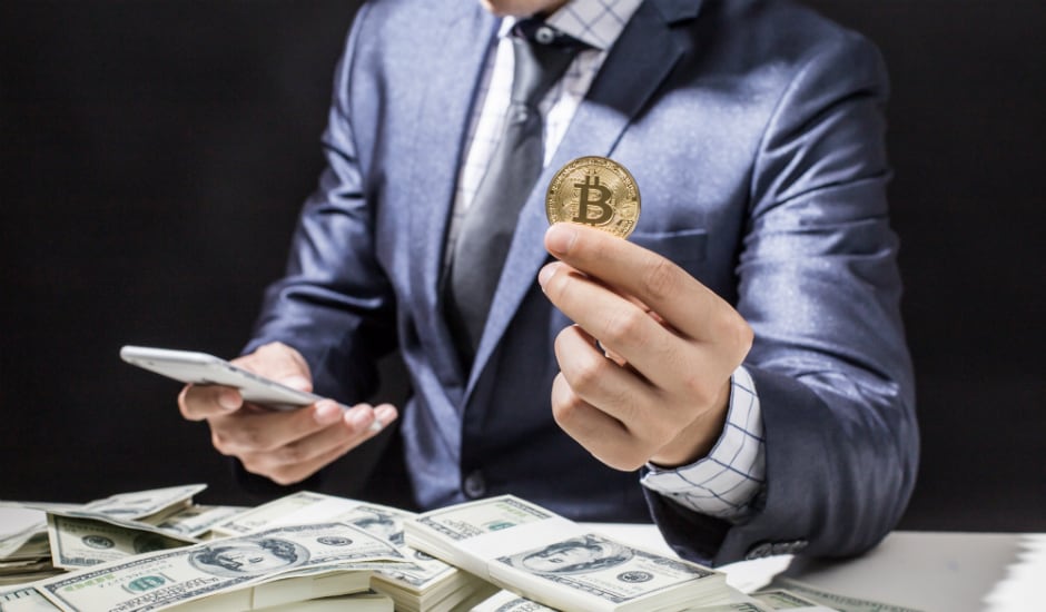 Man holding a Bitcoin. Source: Shutterstock