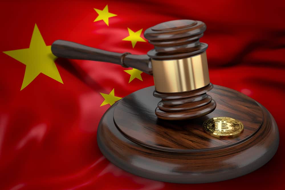 Bitcoin and judge gavel laying on flag of China. Source: Shutterstock.com