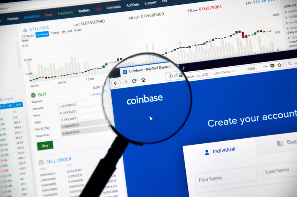 Coinbase cryptocurrency exchange website under magnifying glass. Source: Shutterstock.com