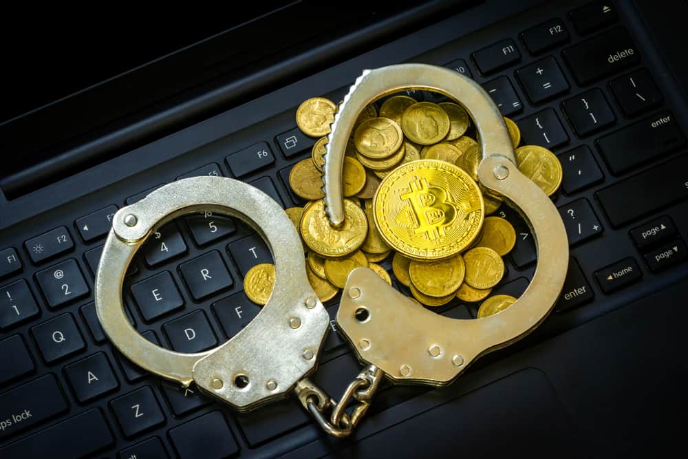 Golden Bitcoins (Cryptocurrency) with Handcuffs on computer keyboard.. Source: shutterstock.com
