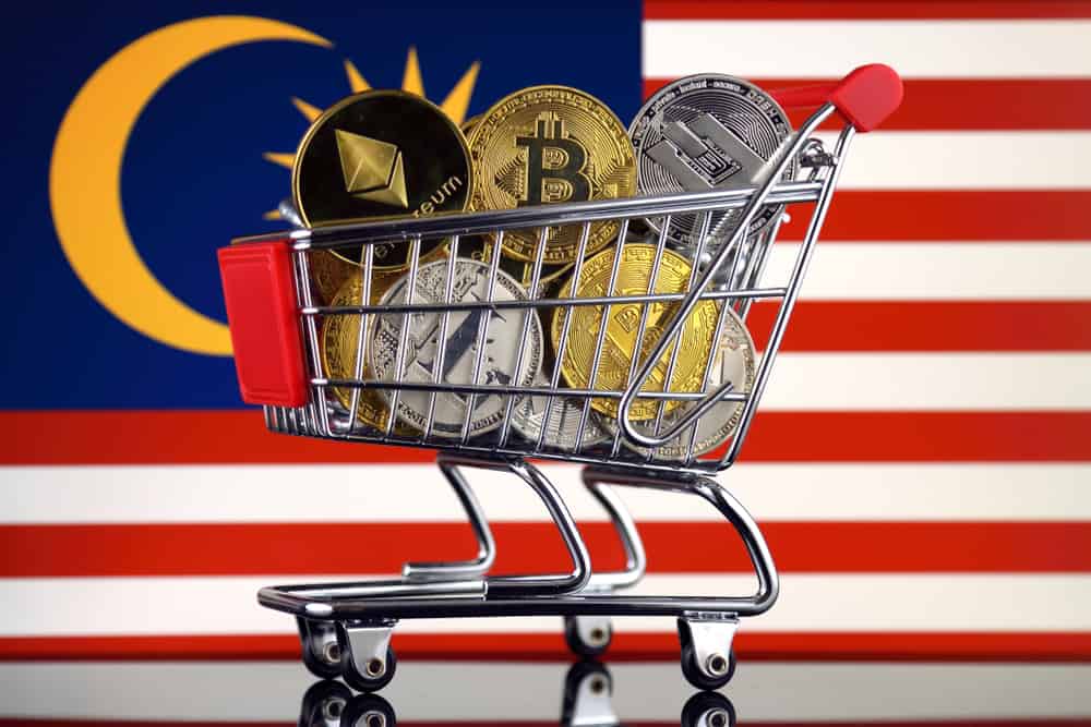 Shopping Trolley full of physical version of Cryptocurrencies (Bitcoin, Litecoin, Dash, Ethereum) and Malaysia Flag. Source: shutterstock.com