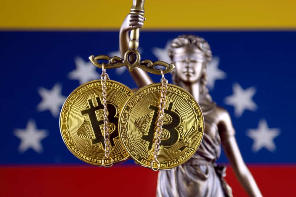 Symbol of law and justice, physical version of Bitcoin and Venezuela Flag. Source: Shutterstock.com