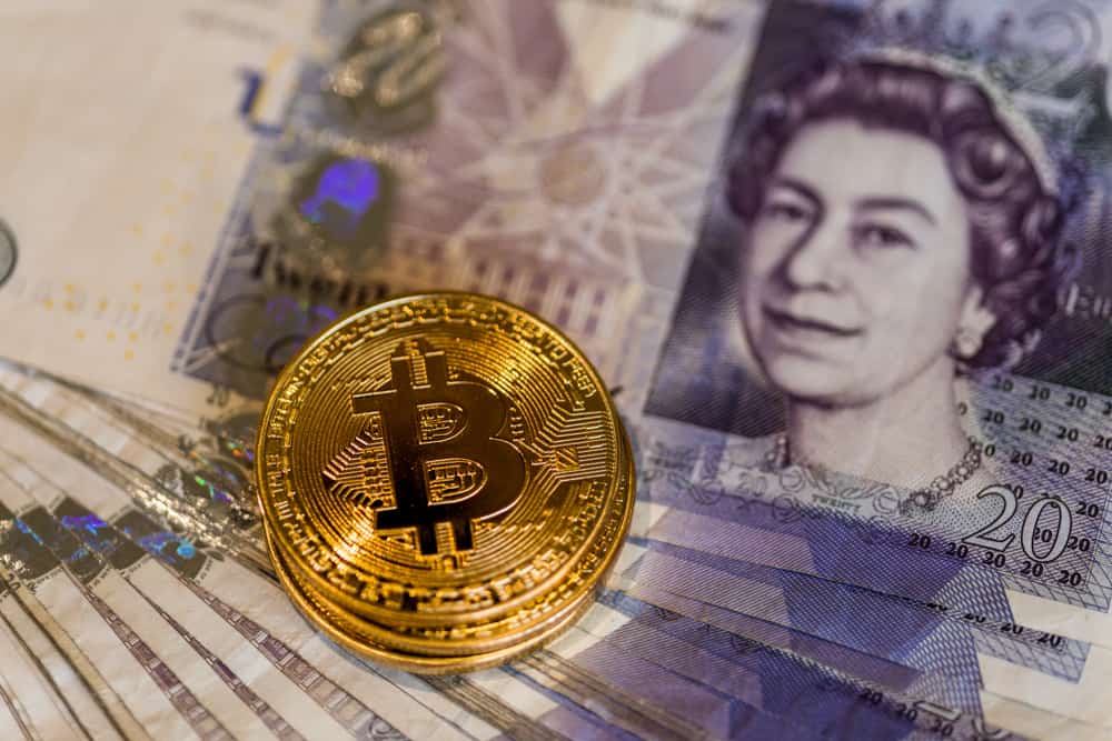 Bitcoins over British pound notes. Source: shutterstock.com