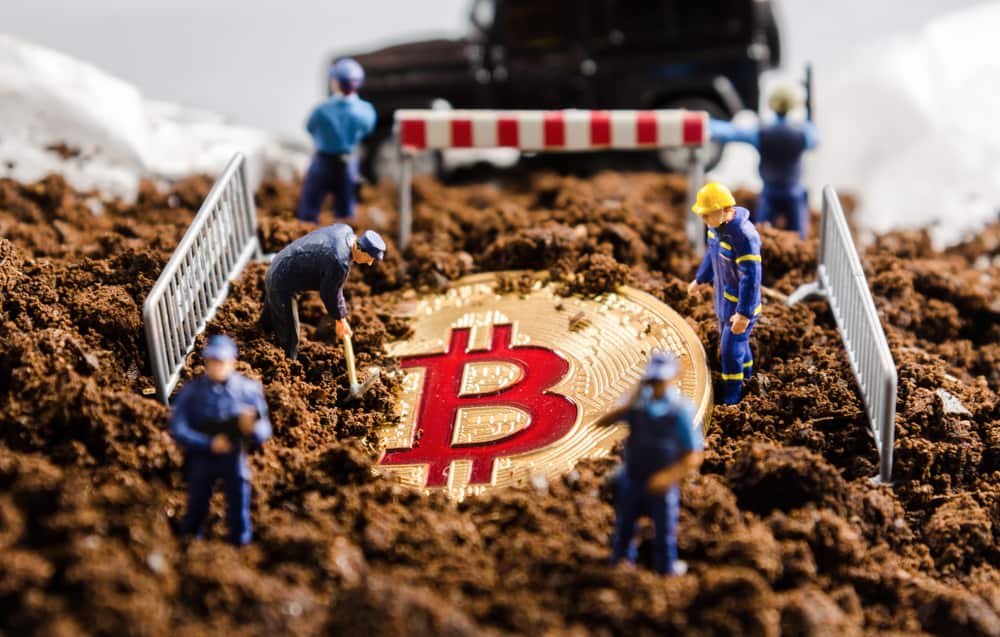 miniature miner workers team digging gold bitcoin with policeman officers stand watch over. digital virtual cryptocurrency money blockchain concept. Source: shutterstock.com