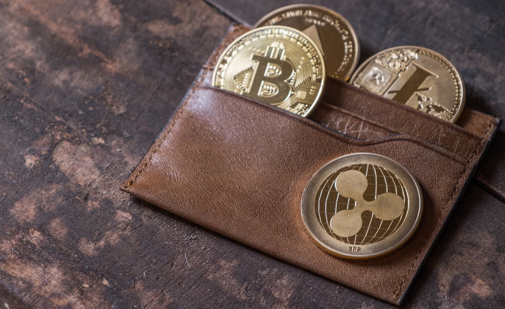 Popular cryptocurrency in leather wallet on wooden table top. Source: shutterstock.com