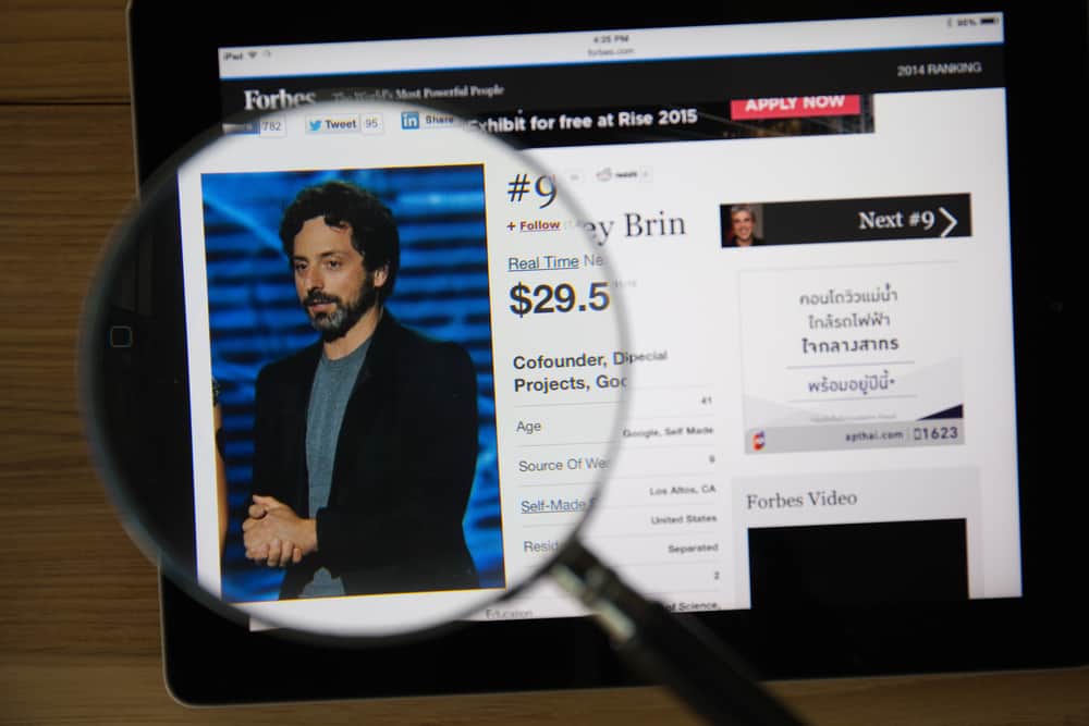 CHIANGMAI, THAILAND - March 31, 2015: Photo of Forbes article page about Sergey Brin on a ipad monitor screen through a magnifying glass. Source: shutterstock.com