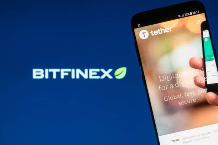 KYRENIA, CYPRUS - OCTOBER 3, 2018 Tether cryptocurrency website displayed on the smartphone screen with blurred Bitfinex logo on background. Source: shutterstock.com