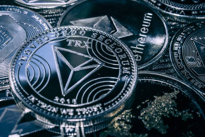 Coin cryptocurrency Tron on the background of the main altcoins Ethereum, dash, monero, litecoin, Iota. - Image