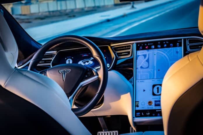 Dubai United Arab Emirates - 08032018 Interior of the Tesla Model S P100D electric car on an empty road in Dubai at sunset - Image
