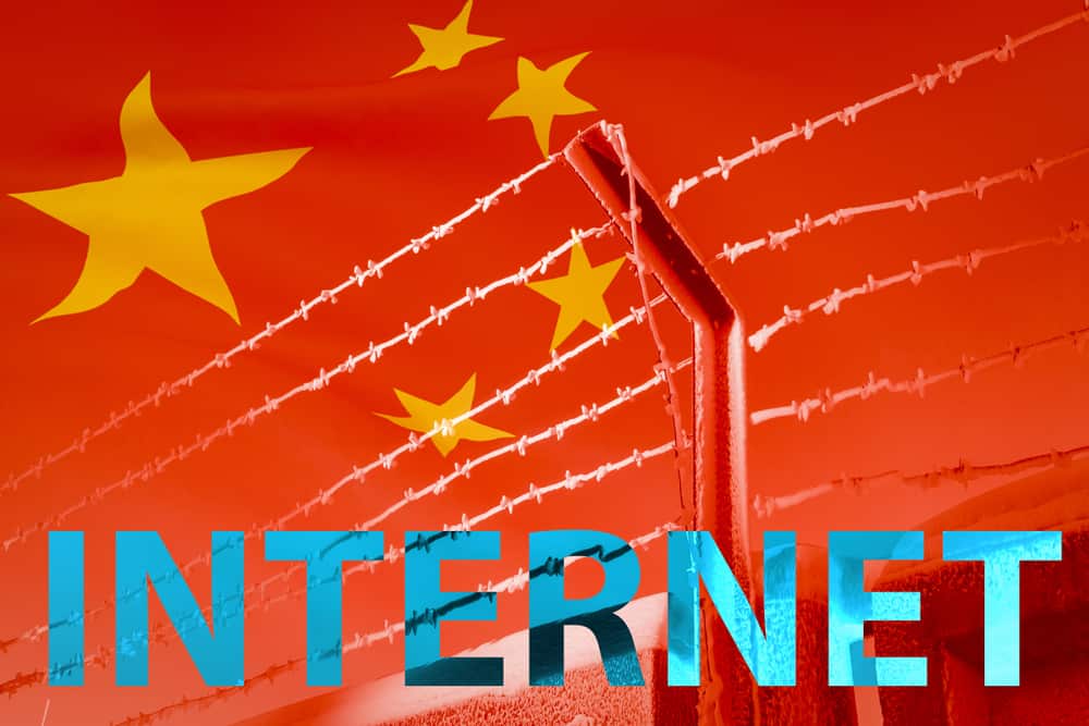 The inscription INTERNET in front of a barbed wire fence on the background of the developing Chinese flag. Concept the barriers between Nations; the restriction of the Internet. - Illustration
